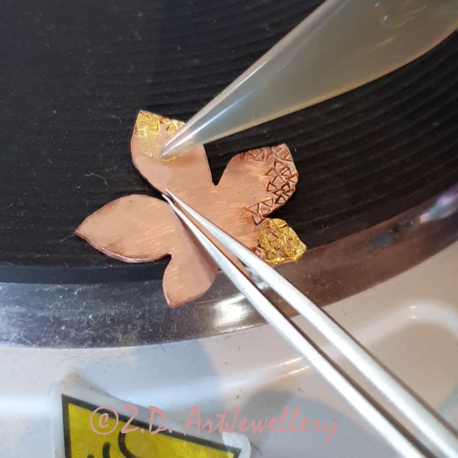 Pressing gold foin on copper